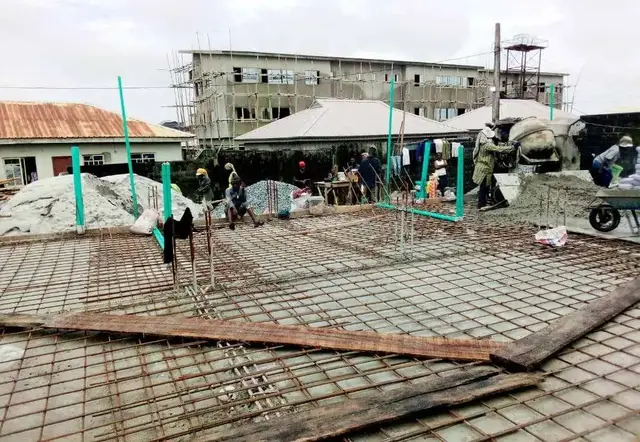 Workers laying conduit on a reinforced slab