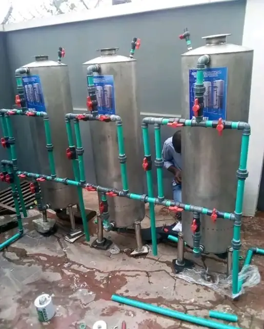 Stainless steel filtration vessels connected with green pipework