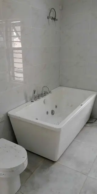 Bathroom with whirlpool bath and toilet installed