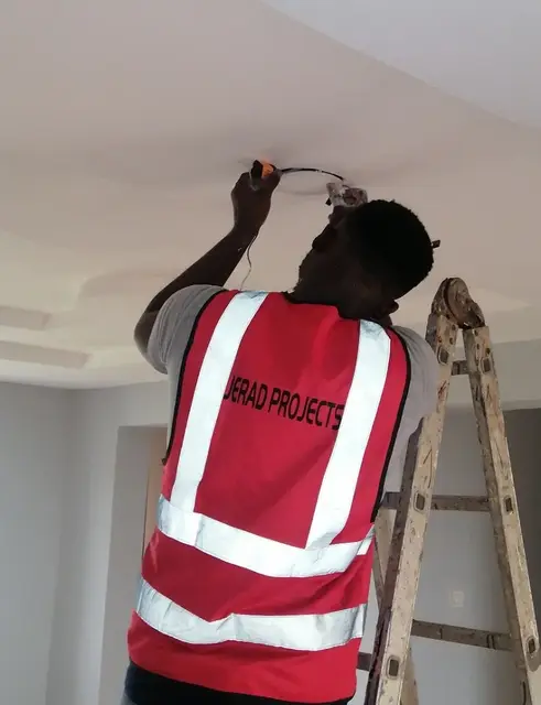 Jerad Projects technician installing a recessed ceiling light