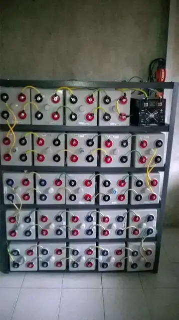 Racks of batteries wired together in a battery room