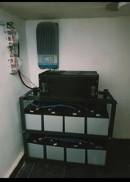 Solar charge controller mounted above a battery rack