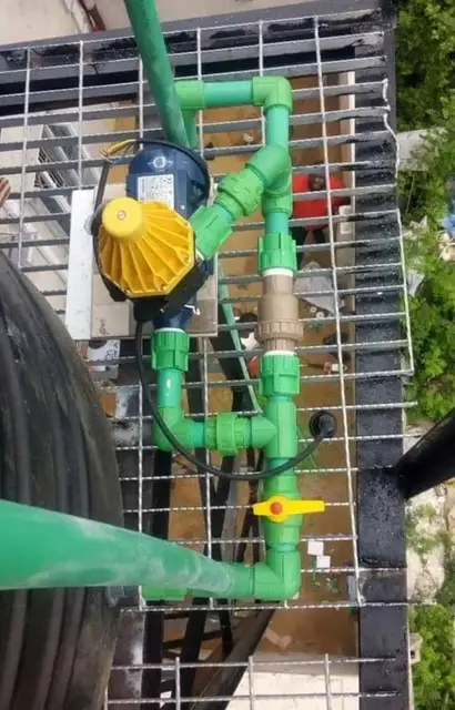 Water pump connected to green PPR pipework