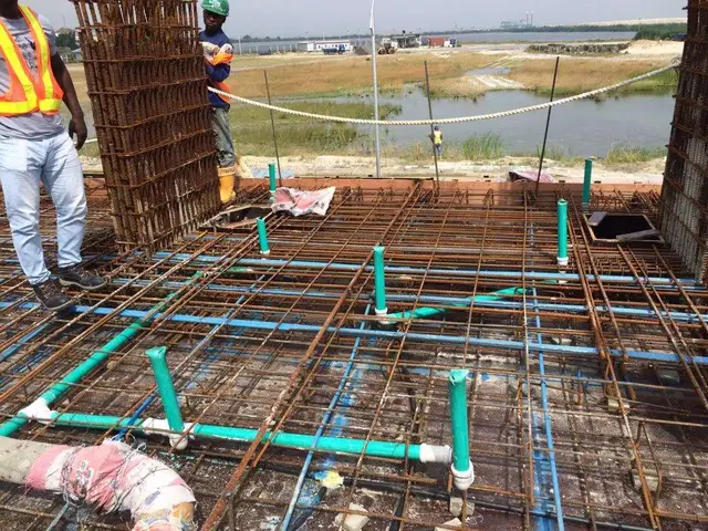 Conduit and plumbing risers on a reinforced slab