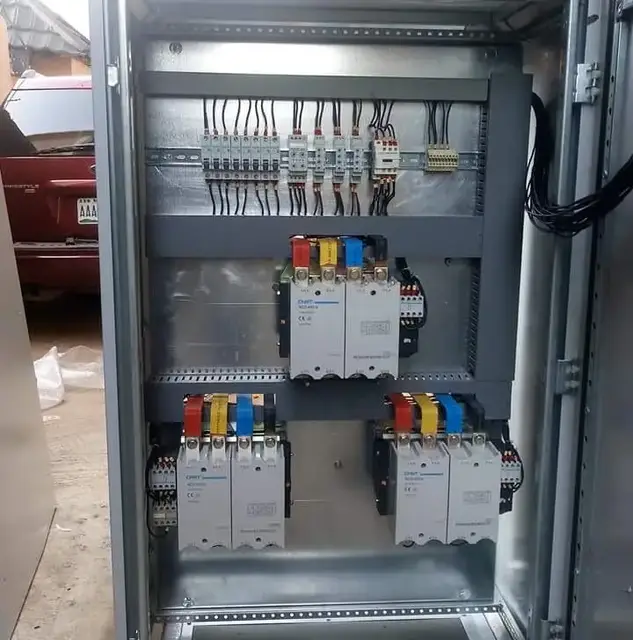Open distribution panel with breakers and contactors