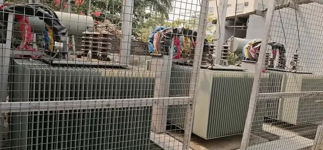 Distribution transformers inside a fenced enclosure